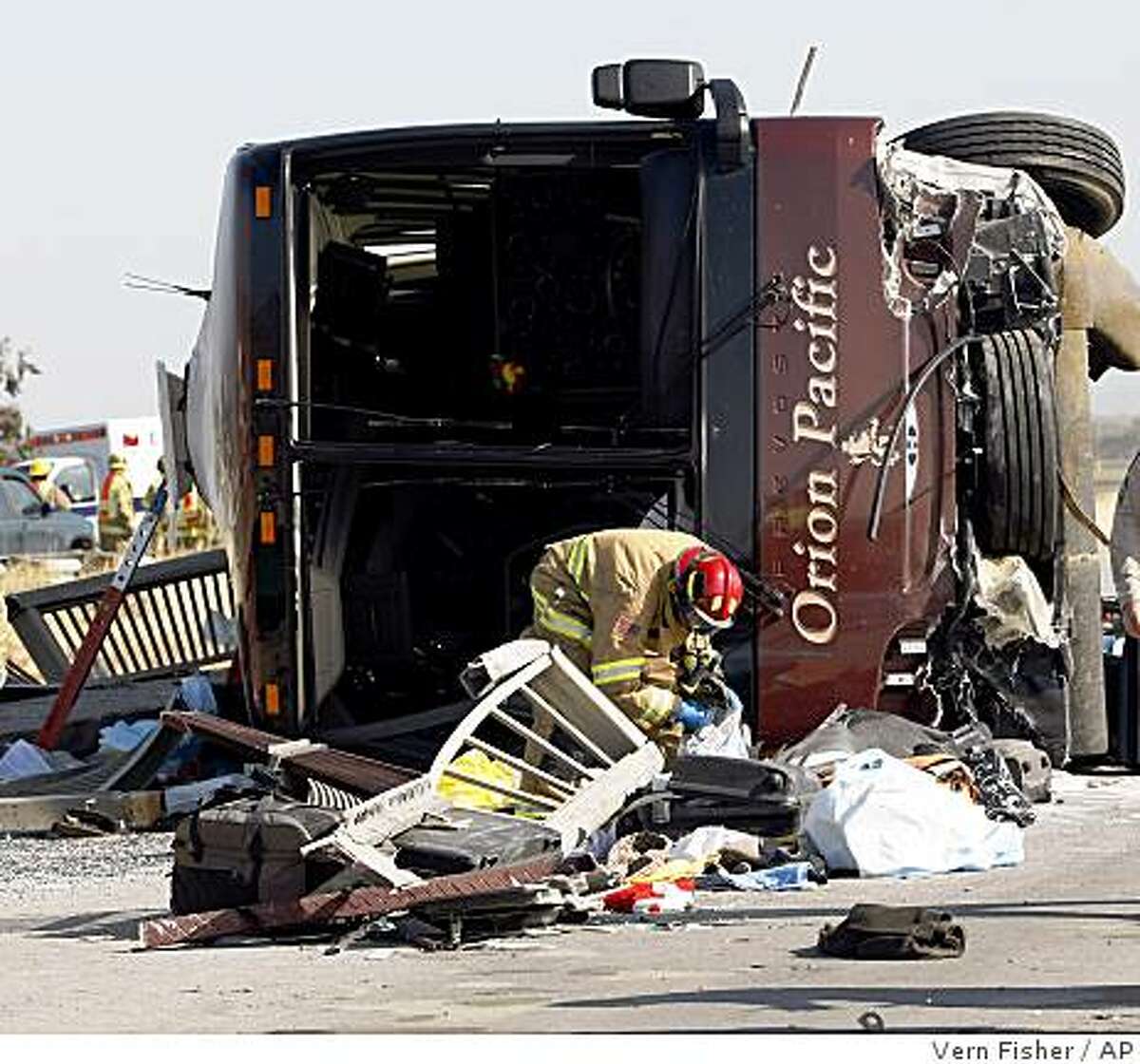 A firefighter investigates the tour bus that crashed Tuesday on U.S. 101 near Soledad.