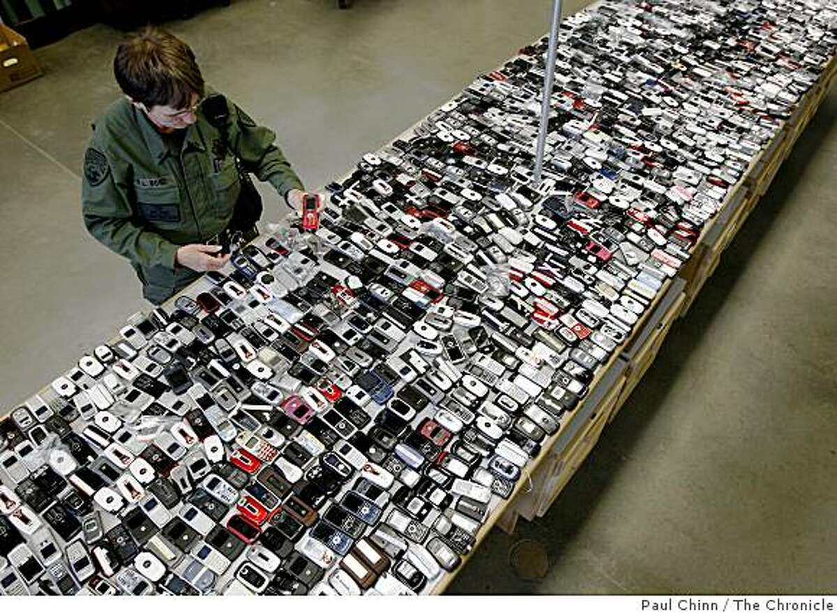 Lt. Robin Bond examines the 1800 cellphones confiscated from prisoners since 2006 at the California State Prison Solano in Vacaville, Calif., on Wednesday, April 29, 2009.