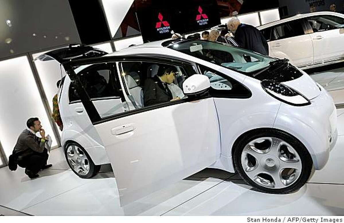The Mitsubishi Motors iMiEV electric prototype vehicle is inspected by members of the media at the New York International Auto Show April 9, 2009 in New York. AFP PHOTO/Stan Honda (Photo credit should read STAN HONDA/AFP/Getty Images)