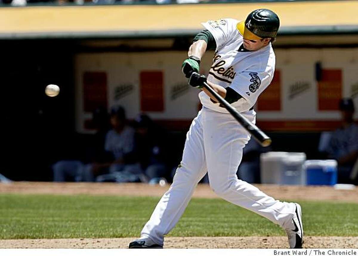 Oakland Athletics' Jack Cust gets a high five after hitting a two