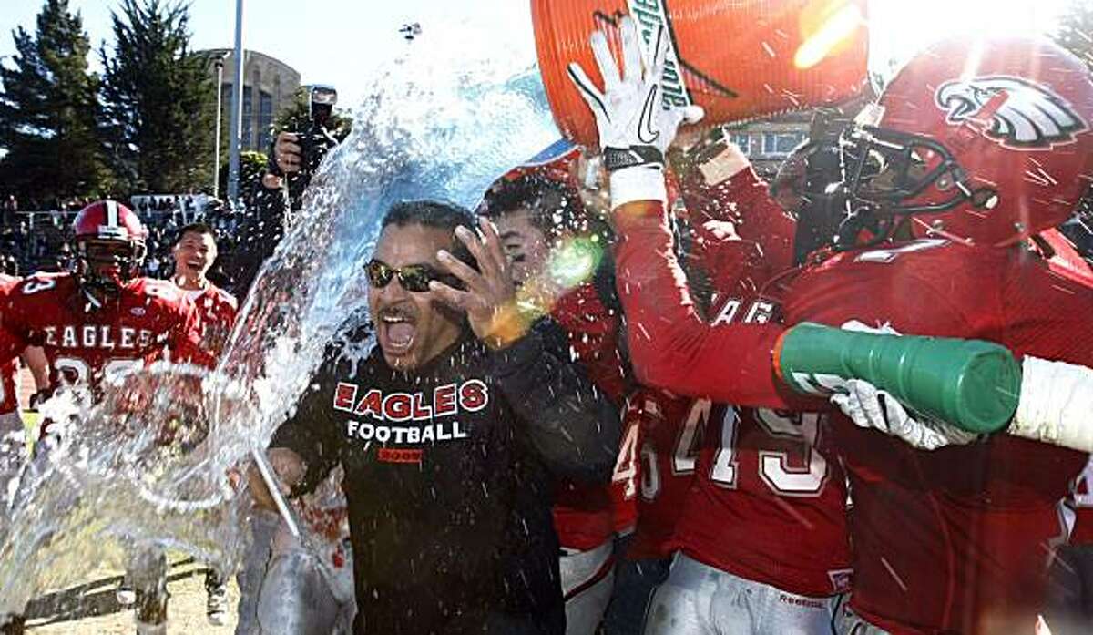 Washington head coach Karl Finley is soaked by players celebrating their victory over Balboa High School in the annual San Francisco Section Turkey Day Bowl Championship at Kezar Stadium on Thursday.