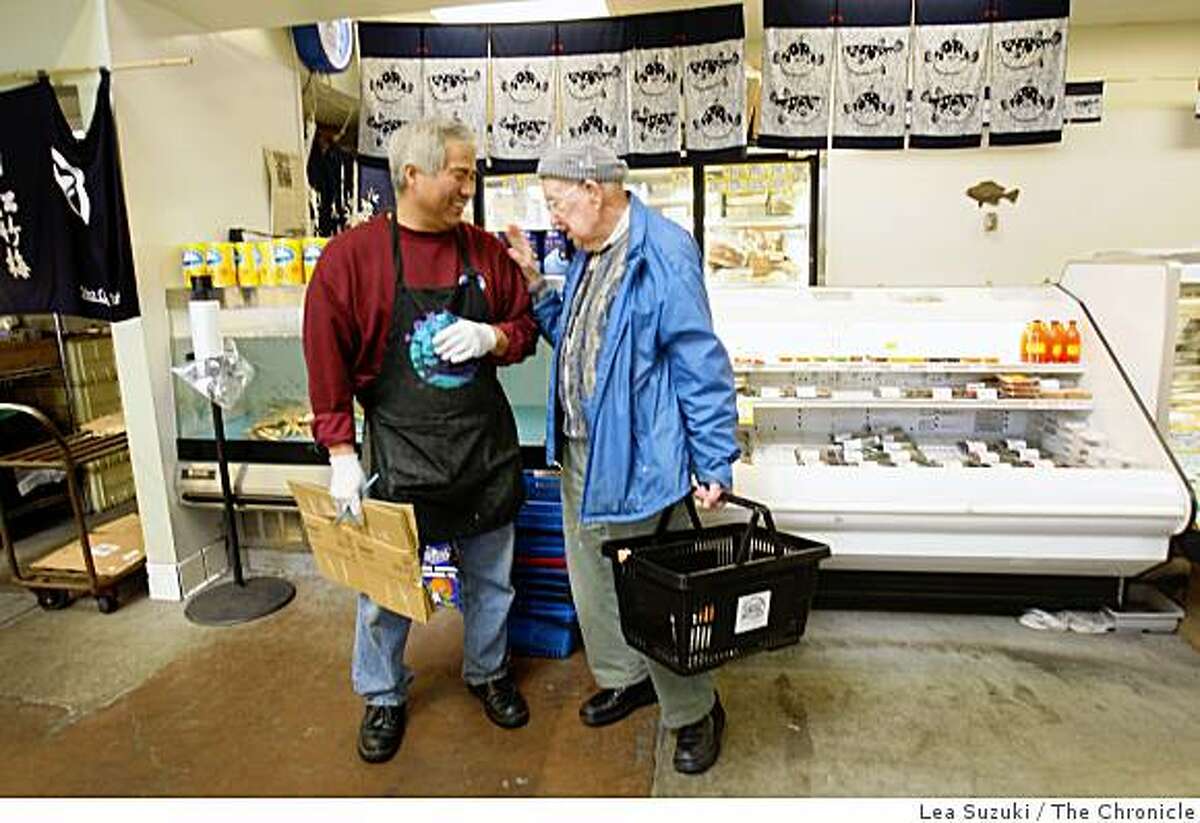 Lee Nakamura (left,) who owns Tokyo Fish Market and Gift Shop with Larry Fujita, shares a laugh with customer Leonard Marks (right) of Piedmont at Tokyo Fish Market in Berkeley, Calif. on Wednesday April 8, 2009.