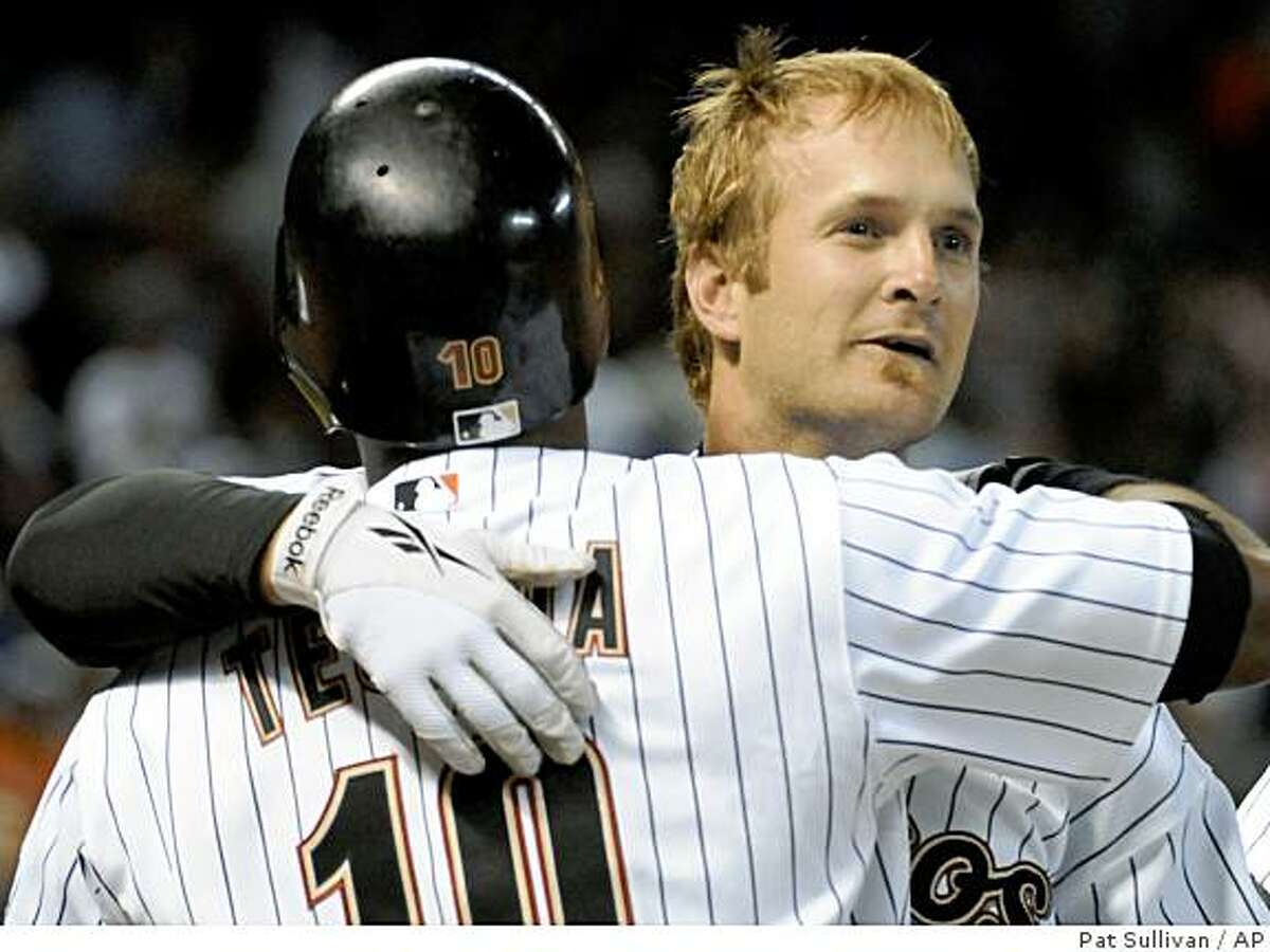 Houston Astros' Jeff Keppinger, right, is congratulated by teammate Miguel Tejada on his bases-loaded, game-winning single in the 10th inning against the Chicago Cubs in a baseball game Tuesday, April 7, 2009, in Houston. The Astros won 3-2. (AP Photo/Pat Sullivan)