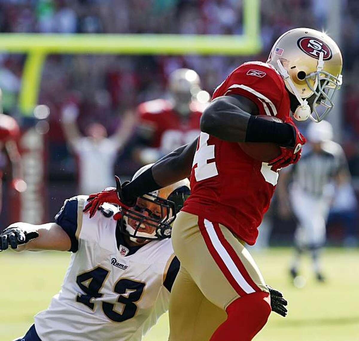 Josh Morgan breaks a tackle by the Rams' Craig Dahl on his 65-yard catch and run in the first quarter at Candlestick Park in San Francisco on Sunday.