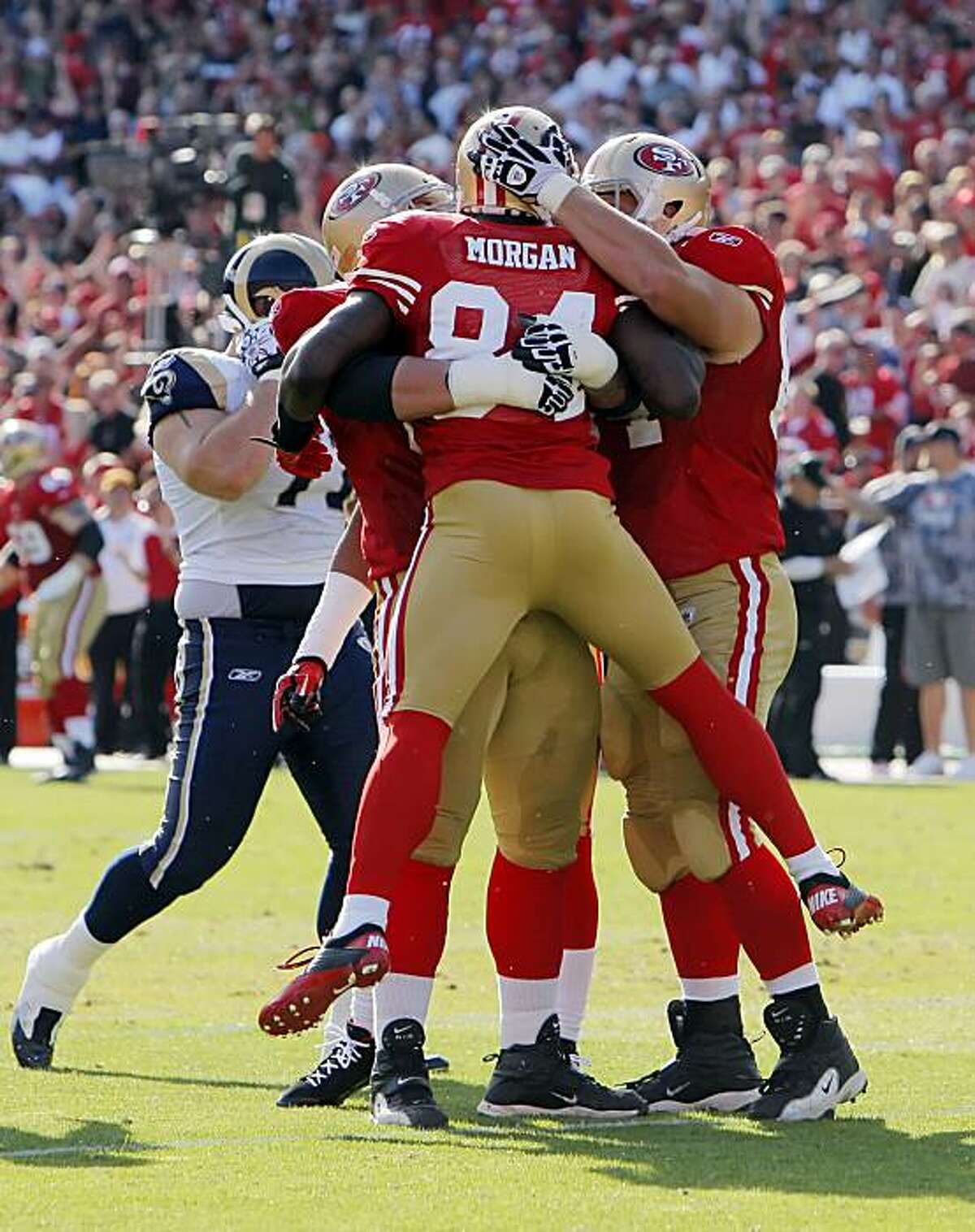 Josh Morgan celebrates his 65-yard reception with teammates in the first quarter against the Rams at Candlestick Park in San Francisco on Sunday. The catch led to a touchdown by Frank Gore.