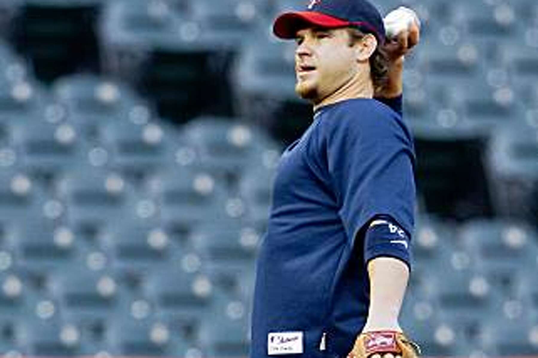 Minnesota Twins' Joe Crede stands on the field after flying out to