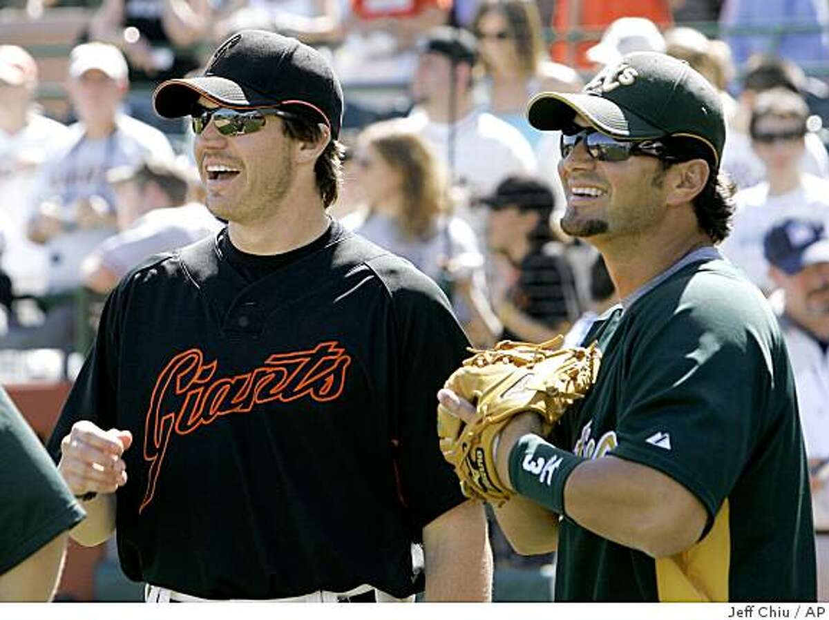 San Francisco Giants pitcher Barry Zito, left, talks with Oakland Athletics' Eric Chavez before the two teams played in a spring training baseball game in Scottsdale, Ariz., Friday, March 9, 2007. (AP Photo/Jeff Chiu)