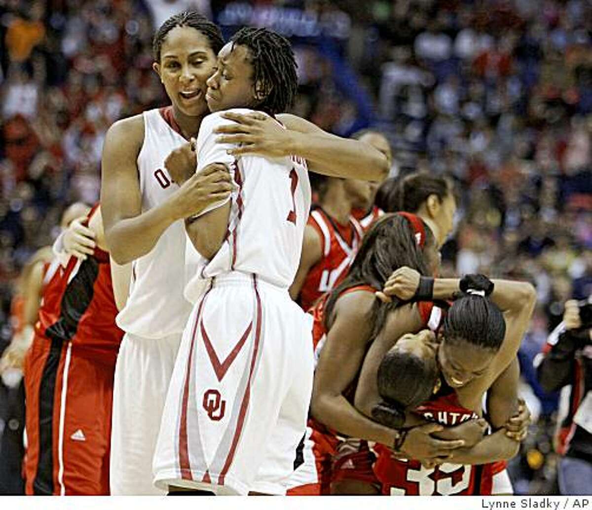 Oklahoma's Ashley Paris, left, comforts Nyeshia Stevenson (1) after Oklahoma lost to Louisville 61-59 in a semifinal of the NCAA women's college basketball tournament Final Four on Sunday, April 5, 2009, in St. Louis. (AP Photo/Lynne Sladky)