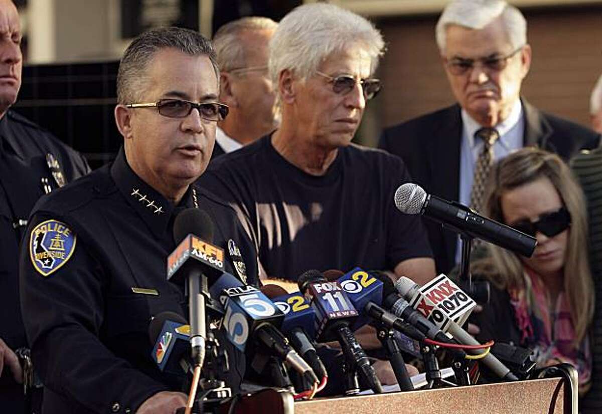 Riverside Chief of Police Sergio Diaz talks about officer Ryan Bonaminio on Tuesday, Nov. 9, 2010 during a news conference outside the Riverside Police Department in Riverside, Calif. as Ryan's father Joseph and sister Nicole, right, look on. Bonaminio, 27, a four-year member of the department and an Iraq War veteran, was on patrol late Sunday when he pulled over a truck. The driver got out and Bonaminio chased him into nearby Fairmount Park. The two exchanged gunshots and at least one hit Bonaminio, Lt. Leon Phillips said. Backup officers found him on the ground, and he was declared dead at a hospital. (AP Photo/The Press Enterprise, Stan Lim) MANDATORY CREDIT, NO SALES, MAGS OUT