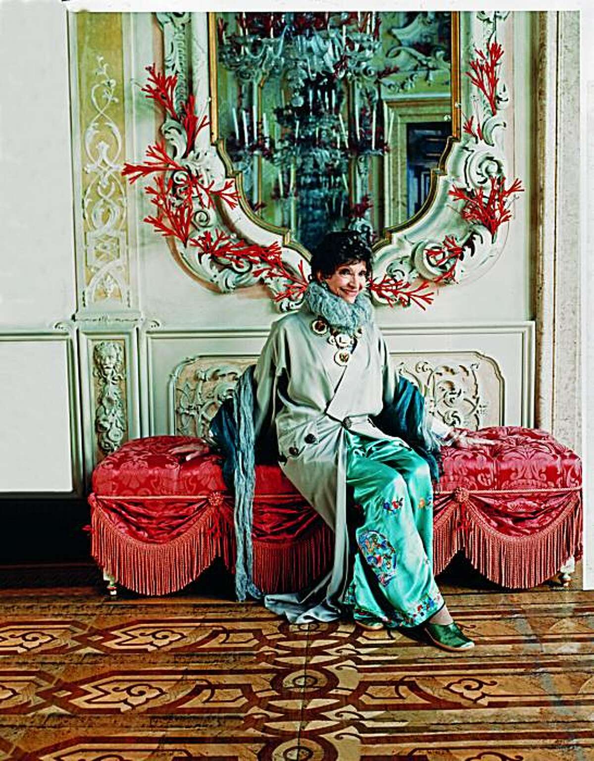International hostess and fashionista Dodie Rosekrans and her late husband, John Rosekrans, had the late interior designer Tony Duquette and his design partner, Hutton Wilkinson, transform a palazzo on Venice, Italy's Grand Canal into a fantasy palace. Here, Dodie sits under a mirror adorned with coral "antlers" in the ballroom. She is wearing Galliano haute couture. The home is featured in the new book, "At Home with Town & Country," (Hearst Books, 2010.) Reprinted with permission from At Home with Town & Country, copyright 2010 by Hearst Books, a division of Sterling Publishing Co., Inc.”