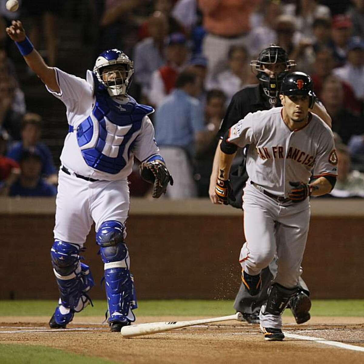 Texas Rangers catcher Bengie Molina throws the ball to first to get the out on San Francisco Giants right fielder Andres Torres in the first inning of Game 5 of the World Series on Monday.