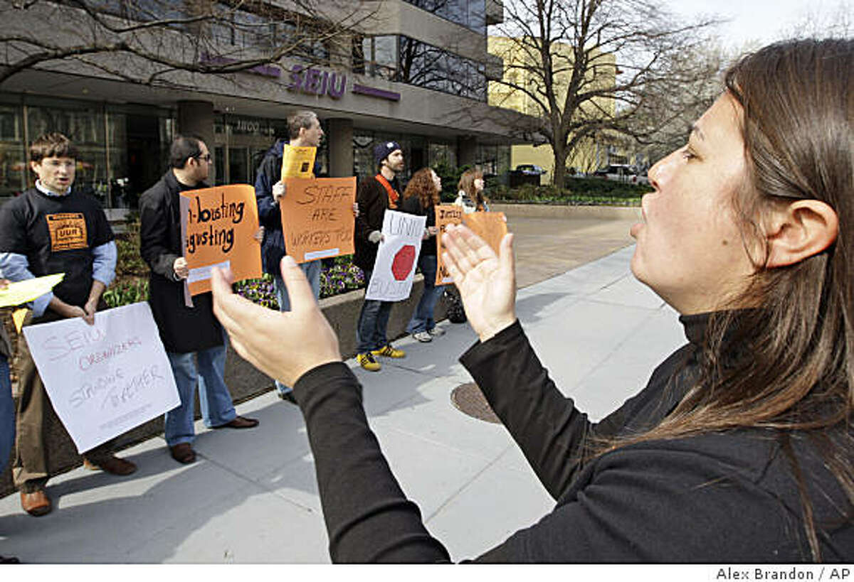 Sarah Solis, right, cheers with other union employees who are picketing their own union, claiming it is unfairly laying off 75 union organizers, Friday, March 27, 2009, Washington. (AP Photo/Alex Brandon)
