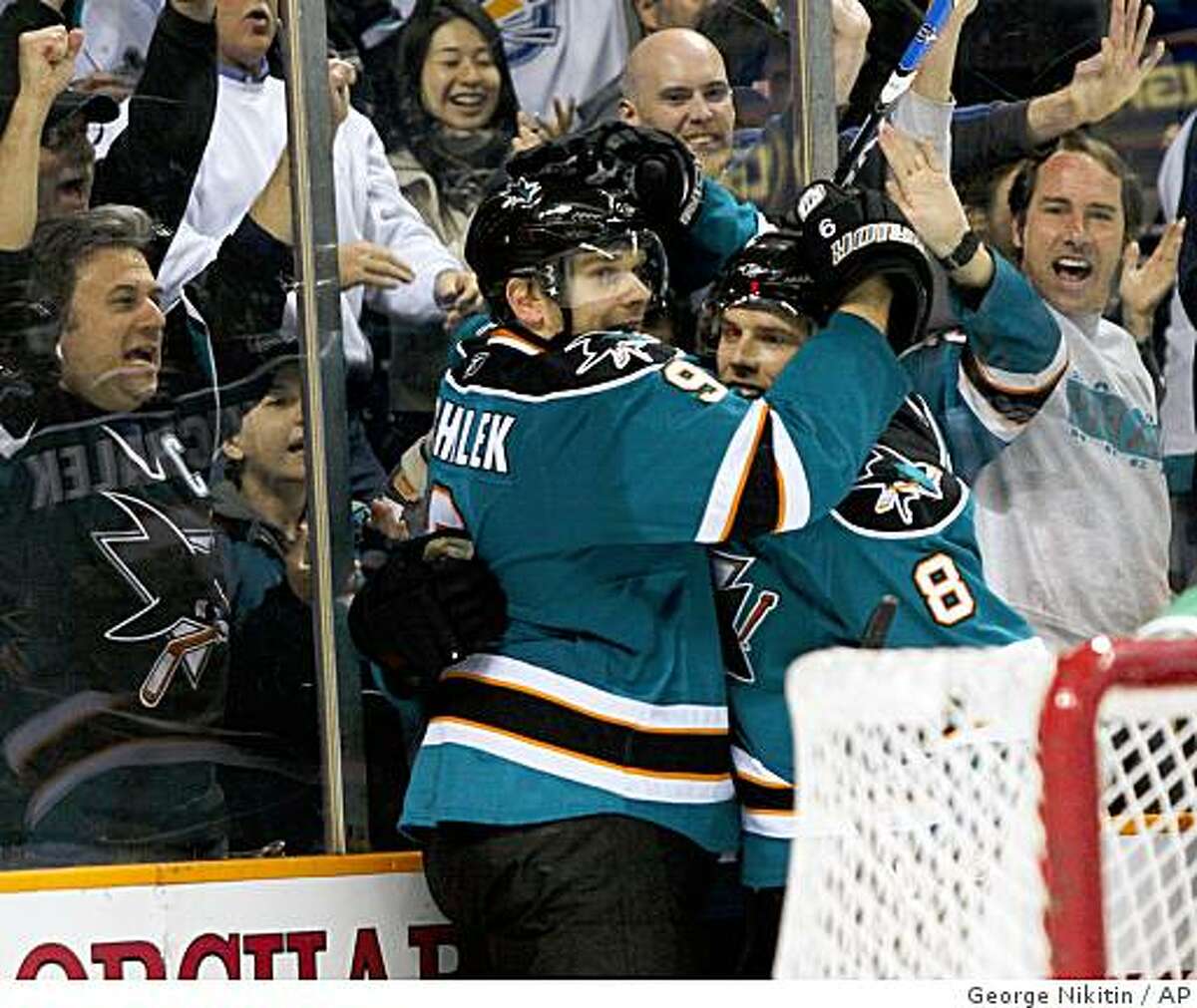 San Jose Sharks' Milan Michalek, left, celebrates with teammate Joe Pavelski after scoring a goal against the Colorado Avalanche during the second period of an NHL hockey game, Sunday, March 22, 2009 in San Jose, Calif. (AP Photo/George Nikitin)
