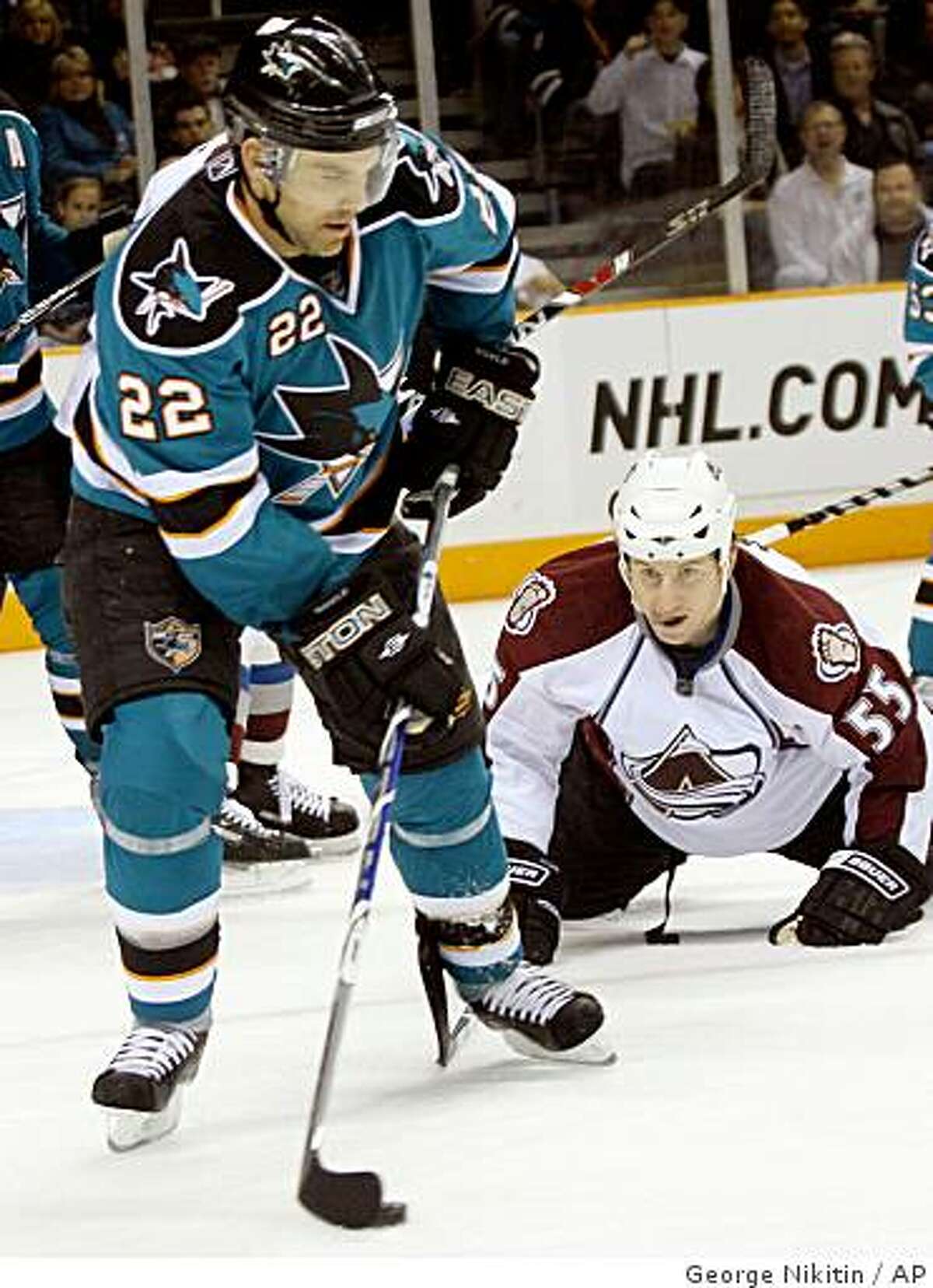 San Jose Sharks' Dan Boyle, front, makes a pass in front of Colorado Avalanche Cody McLead (55),during the second period.