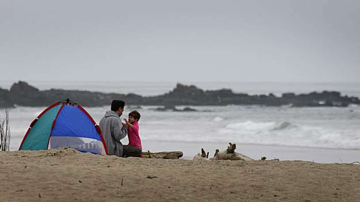 Beach-lovers huddle to stay warm at Pescadero State Beach in San Mateo County on Saturday, May 30, 2009. Pescadero is on the list of parks scheduled to be closed because of the state's budget crisis.