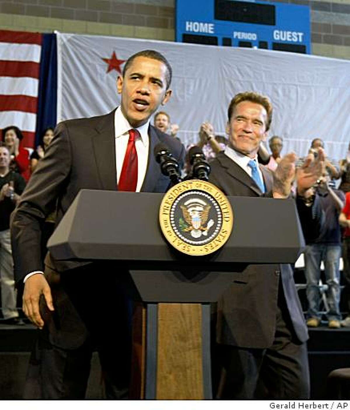 President Barack Obama is applauded by California Gov. Arnold Schwarzenegger upon his arrival at a town hall meeting at the Miguel Contreras Learning Complex in Los Angeles, Thursday, March 19, 2009. (AP Photo/Gerald Herbert)