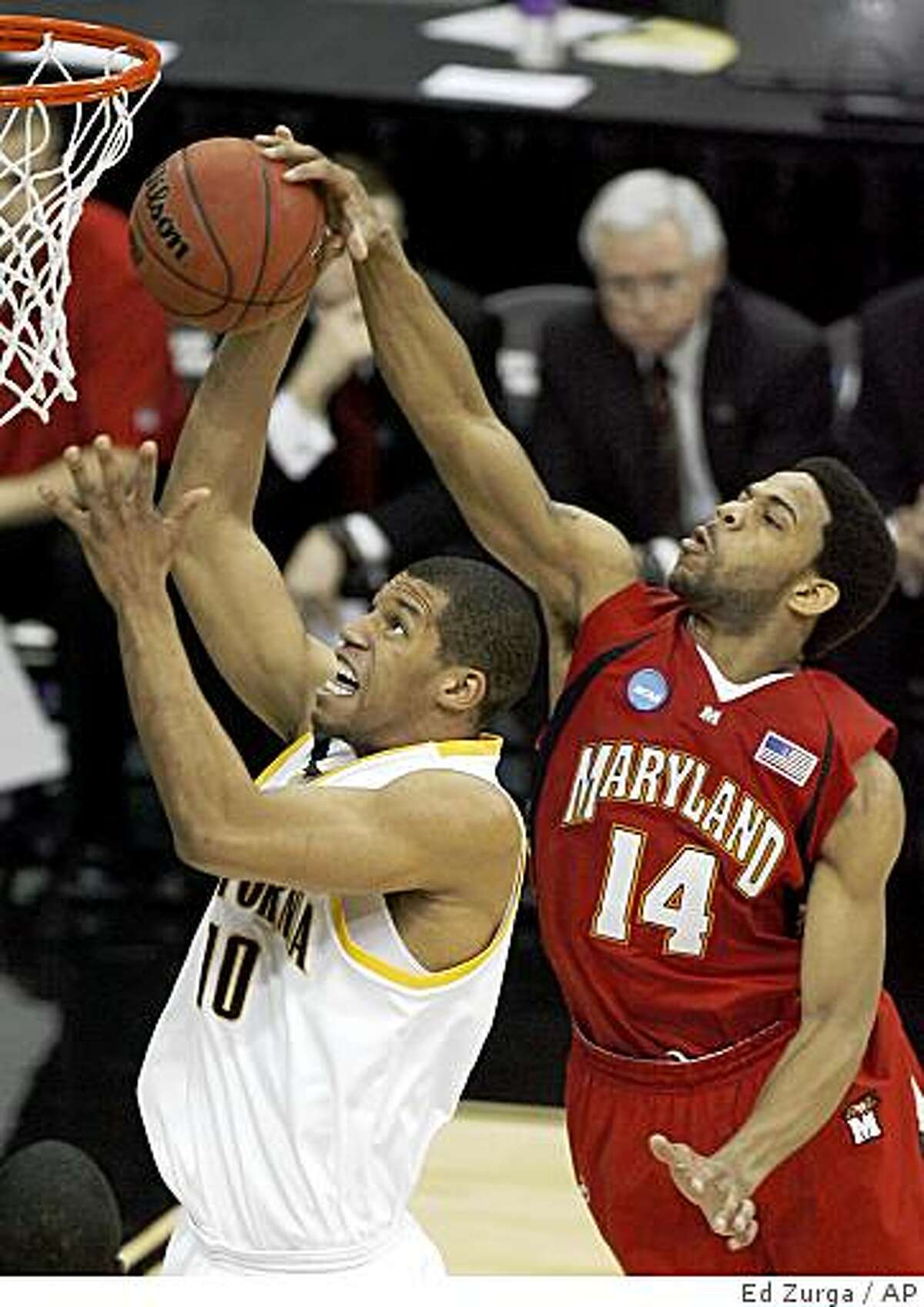 Maryland's Sean Mosley (14) gets a hand on the ball as California's Jamal Boykin (10) tries to make a shot in the first half during a first-round men's NCAA college basketball tournament game in Kansas City, Mo., Thursday, March 19, 2009.