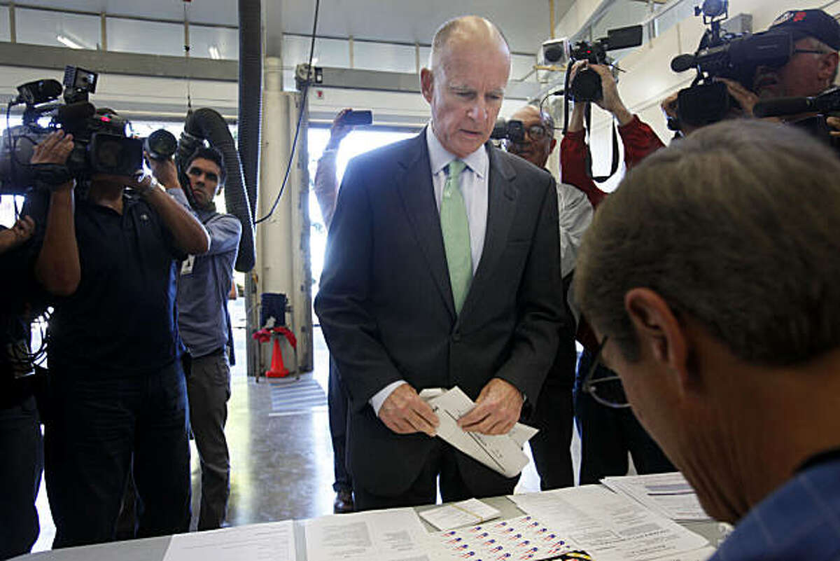 Gubernatorial candidate Jerry Brown checks in with poll workers before voting at Oakland Fire Station No. 6 on Tuesday.