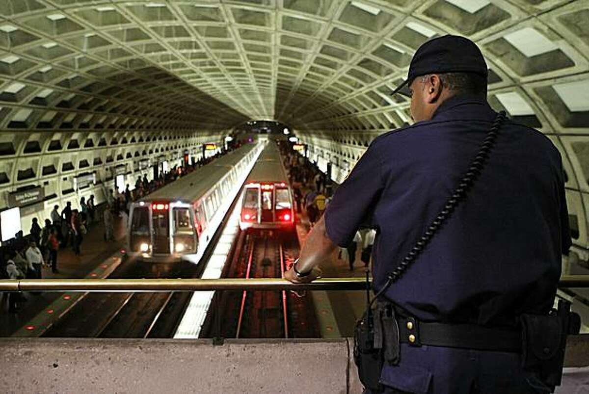 WASHINGTON - OCTOBER 27: A Metro Transit police officer watches Metro trains arrive at the Gallery Pl - Chinatown Station October 27, 2010 in Washington, DC. Farooque Ahmed, a naturalized US citizen originally from Pakistan, of Ashburn, Virginia, was arrested by the FBI for attempting to assist others whom he believed to be members of al-Qaeda in planning multiple bombings at Metrorail stations in the Washington, DC, area. He was taken into custody earlier this morning.