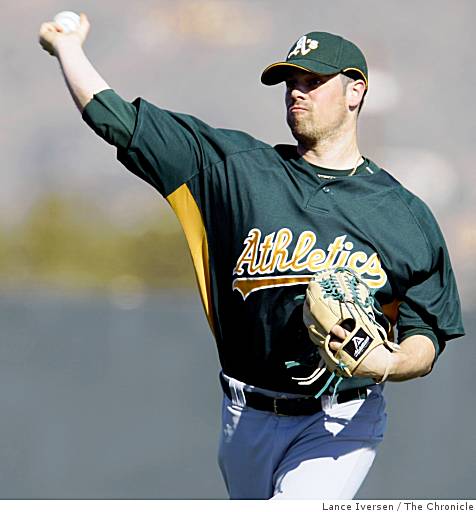 Former Oakland Athletics pitcher Dallas Braden wears a jersey of former San  Francisco Giants pitcher Tim Lincecum before a baseball game between the  Athletics and the Giants in Oakland, Calif., Friday, Aug.