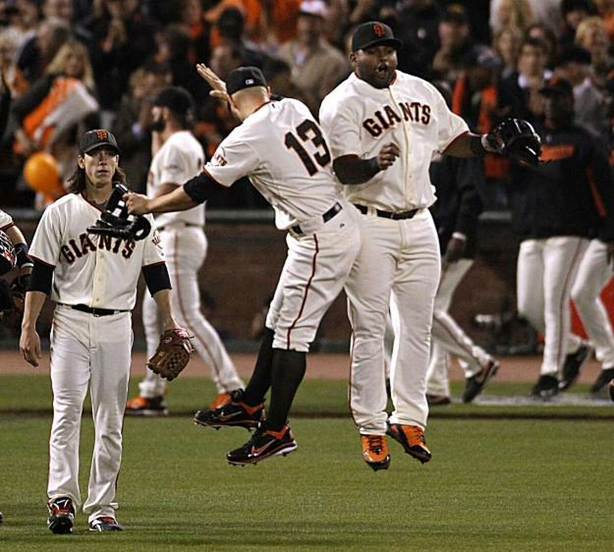 Cody Ross and Pablo Sandoval celebrate after the Giants and Tim Lincecum's win in the first game of the NL Divisional Series over the Atlanta Braves, 1-0, in San Francisco, Calif., on Thursday, Oct. 7, 2010.