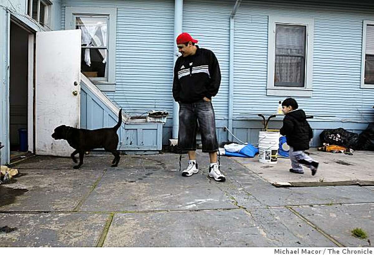 Adolfo Peregrina walks outside with his son, Adolfo Jr., and their dog.