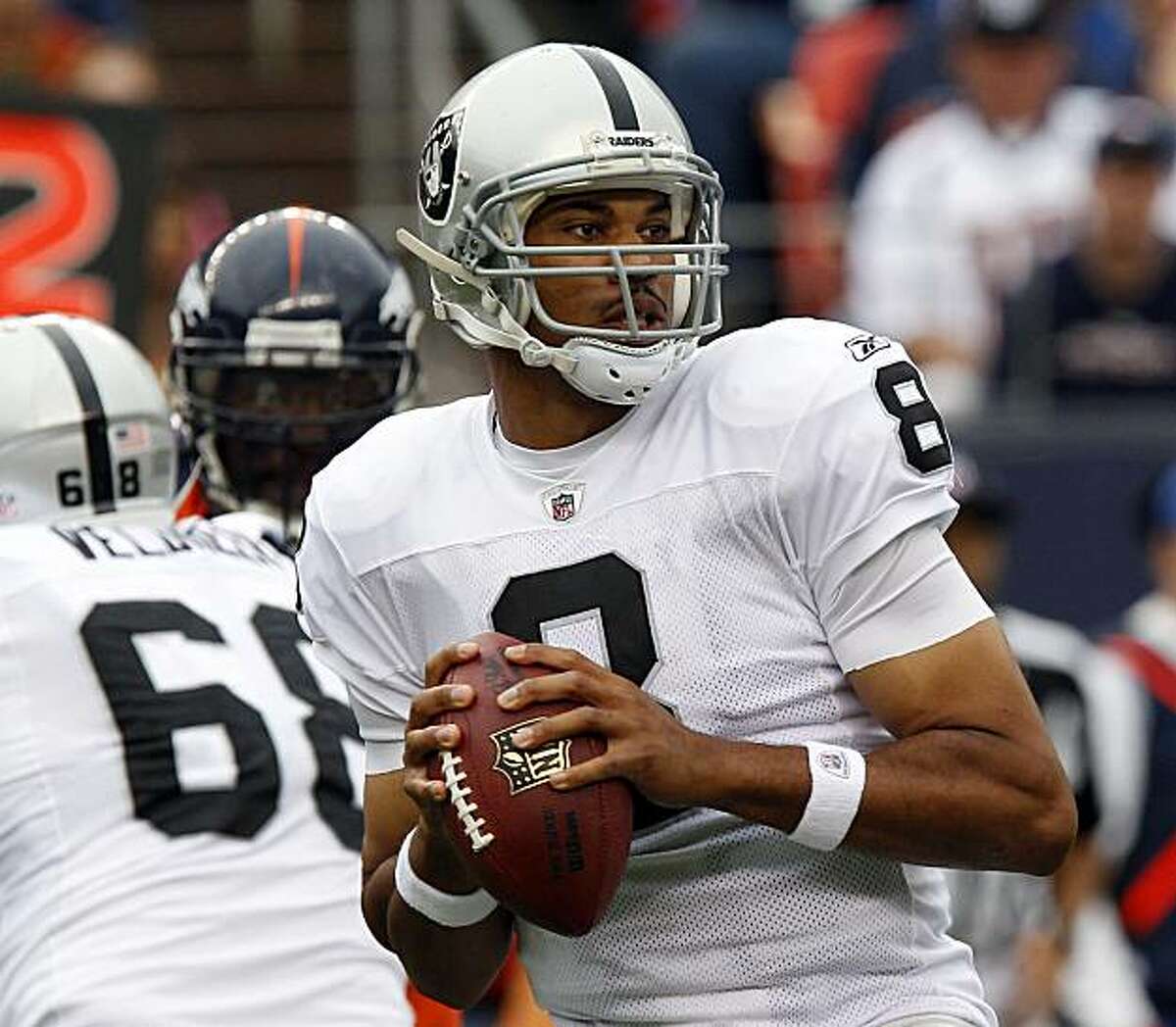 Oakland Raiders quarterback Jason Campbell looks for a receiver during the first half of an NFL football game against the Denver Broncos, Sunday, Oct. 24, 2010, in Denver.