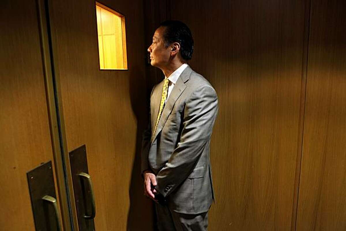 San Francisco Public Defender Jeff Adachi looks through the window into the courtroom to check on the preceding at the Hall of Justice, Tuesday Sept. 29, 2010, in San Francisco, Calif.