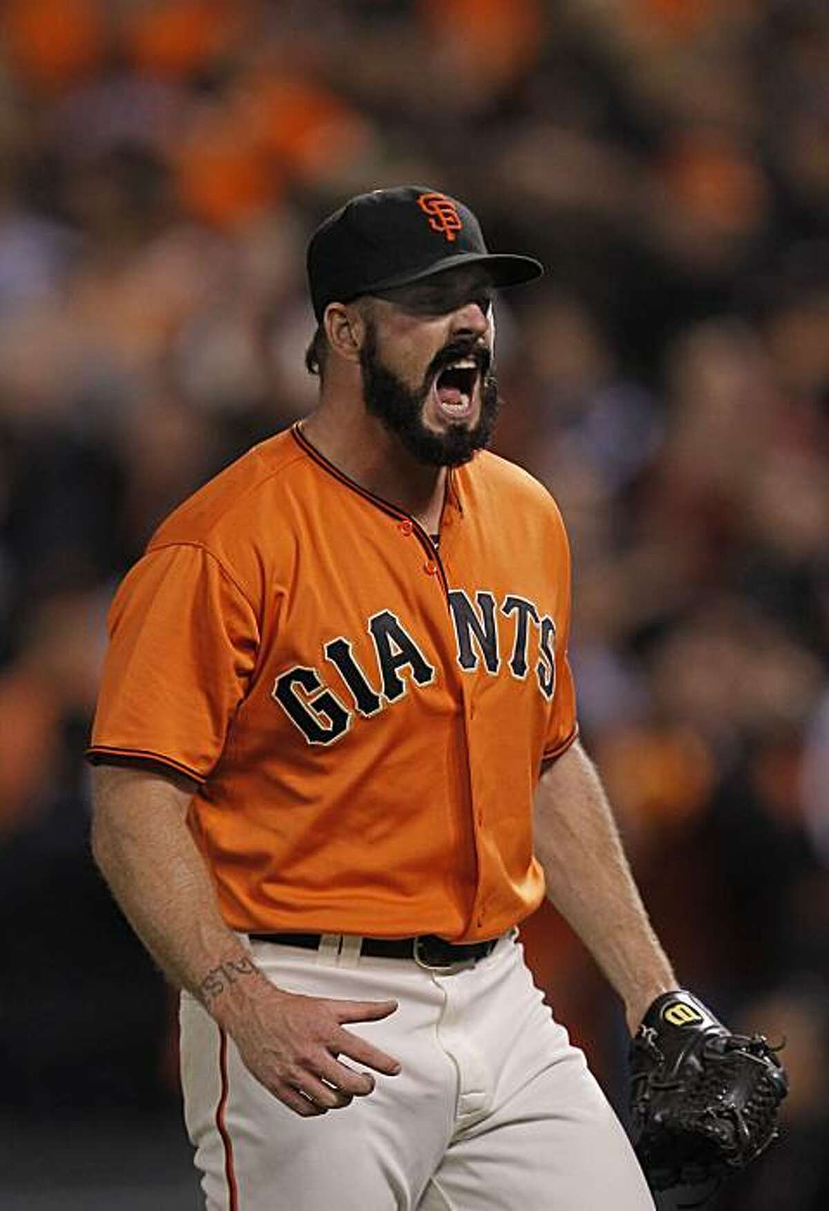 Giants pitcher Brian Wilson reacts as he closes out the 8th inning, as the San Francisco Giants battle the Atlanta Braves in game 2 of the National League Division Series at AT&T Park on Friday Oct. 8, 2010, in San Francisco, Calif.,