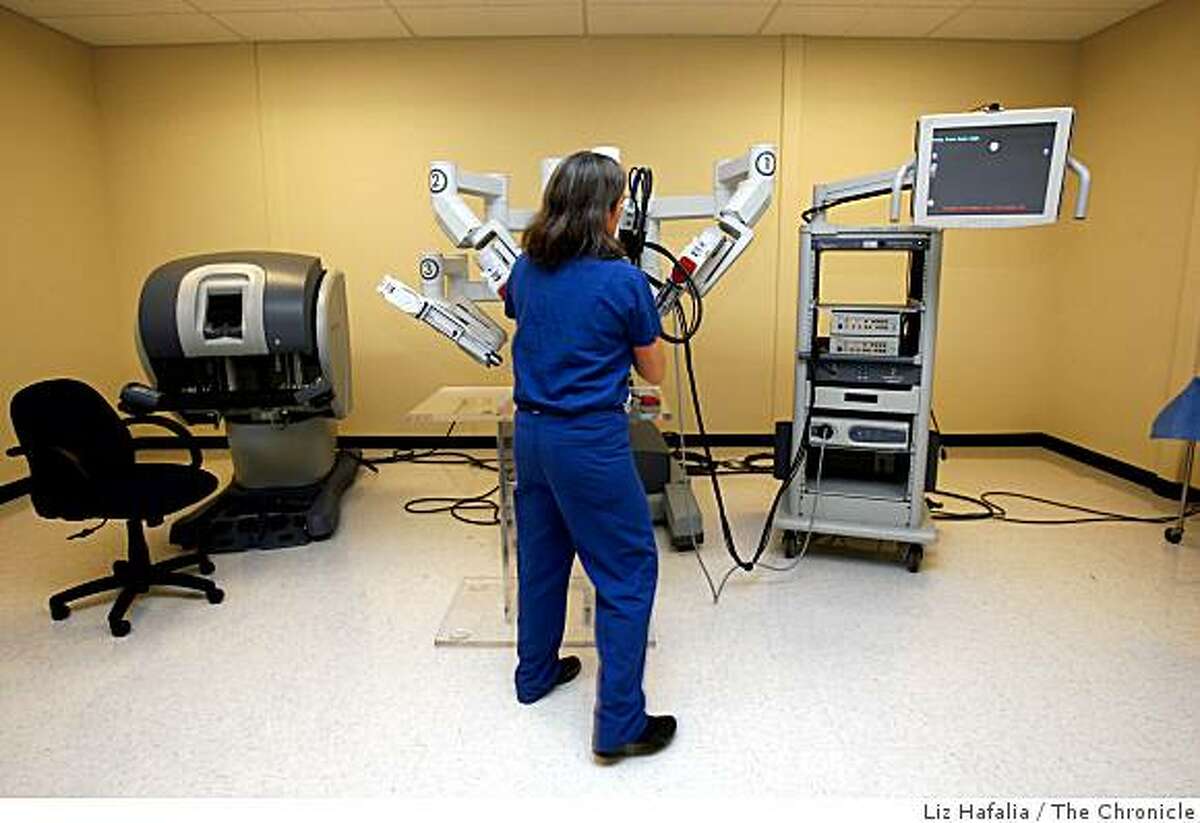 Dr. Catherine Mohr of Stanford Medical School who works for "Intuitive Surgical" company, has developed a robotic arm to be used in difficult surgeries which she is setting up in Sunnyvale, California, on Monday, February 23, 2009.
