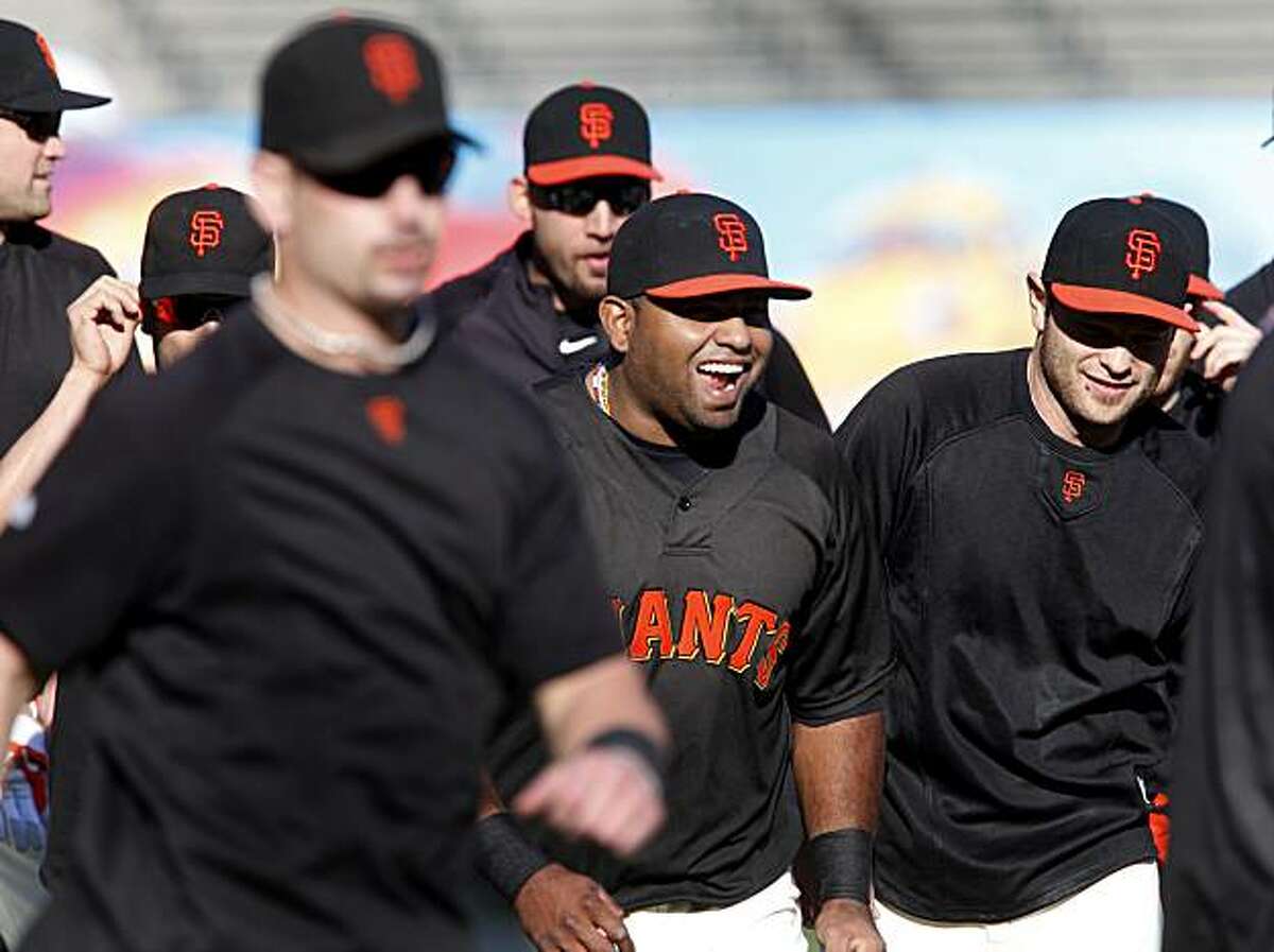 Pablo Sandoval (center) keeps things light during a running drill Monday at AT&T Park.