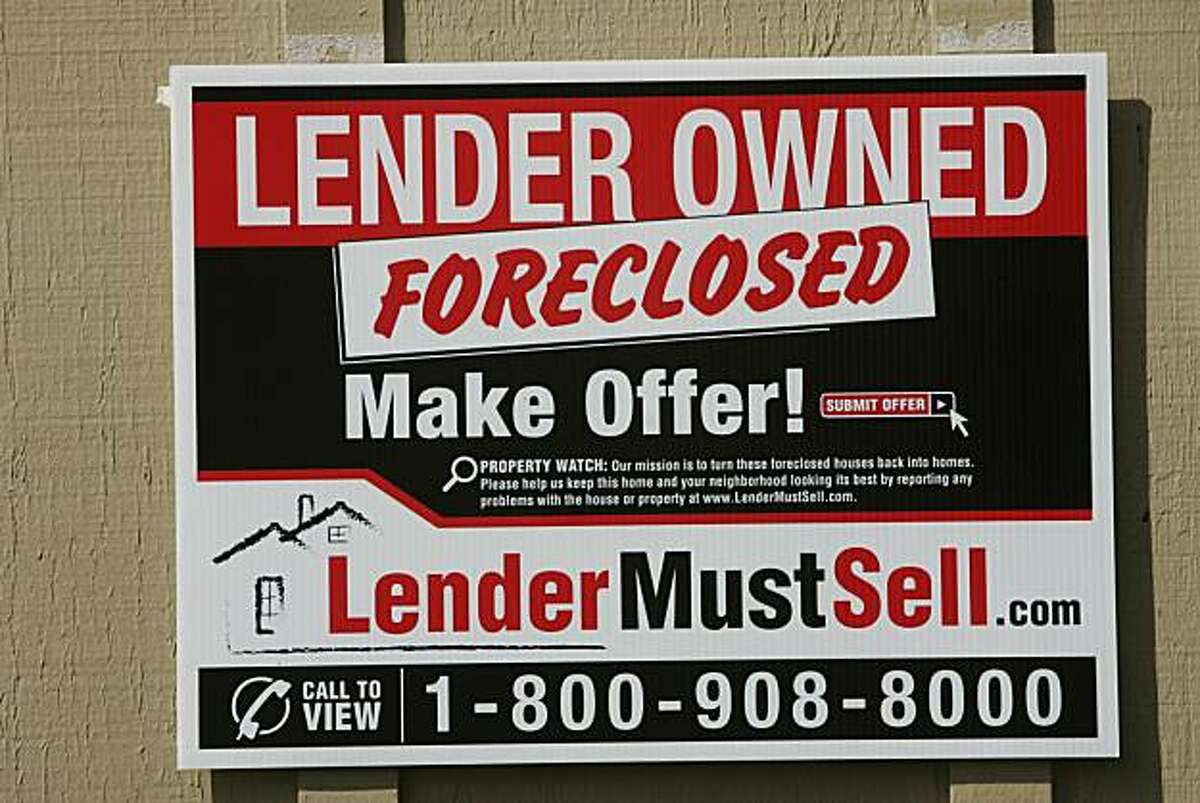 FILE - In this March 11, 2009 file photo, a sign advertising a foreclosed property for sale in Stockton, Calif., is seen. The number of U.S. households facing foreclosure in January increased 15 percent from the same month last year, and a surge in cash-strapped homeowners who've fallen behind on mortgages could be on the way.