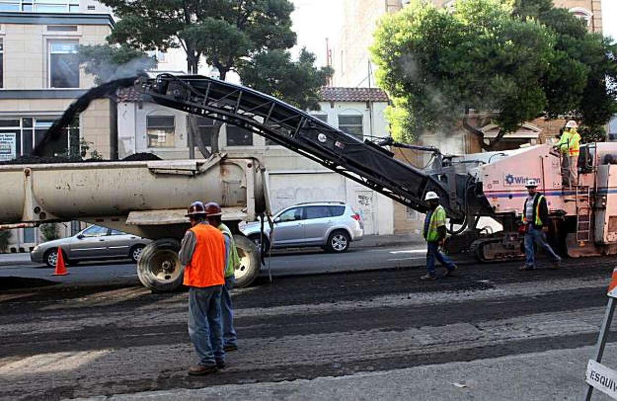 Workers with Esquivel Grading and Paving work on a repaving project on Fell Street between Franklin and Polk Streets on Tuesday Oct. 5, 2010 in San Francisco, Calif.