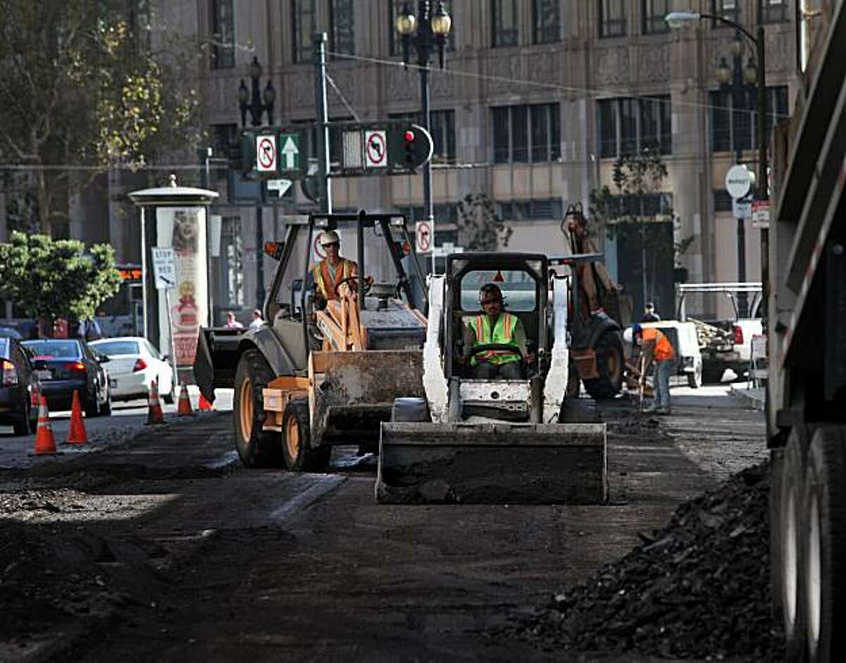 Workers with Esquivel Grading and Paving work on a repaving project on Fell Street between Franklin and Polk Streets on Tuesday Oct. 5, 2010 in San Francisco, Calif.