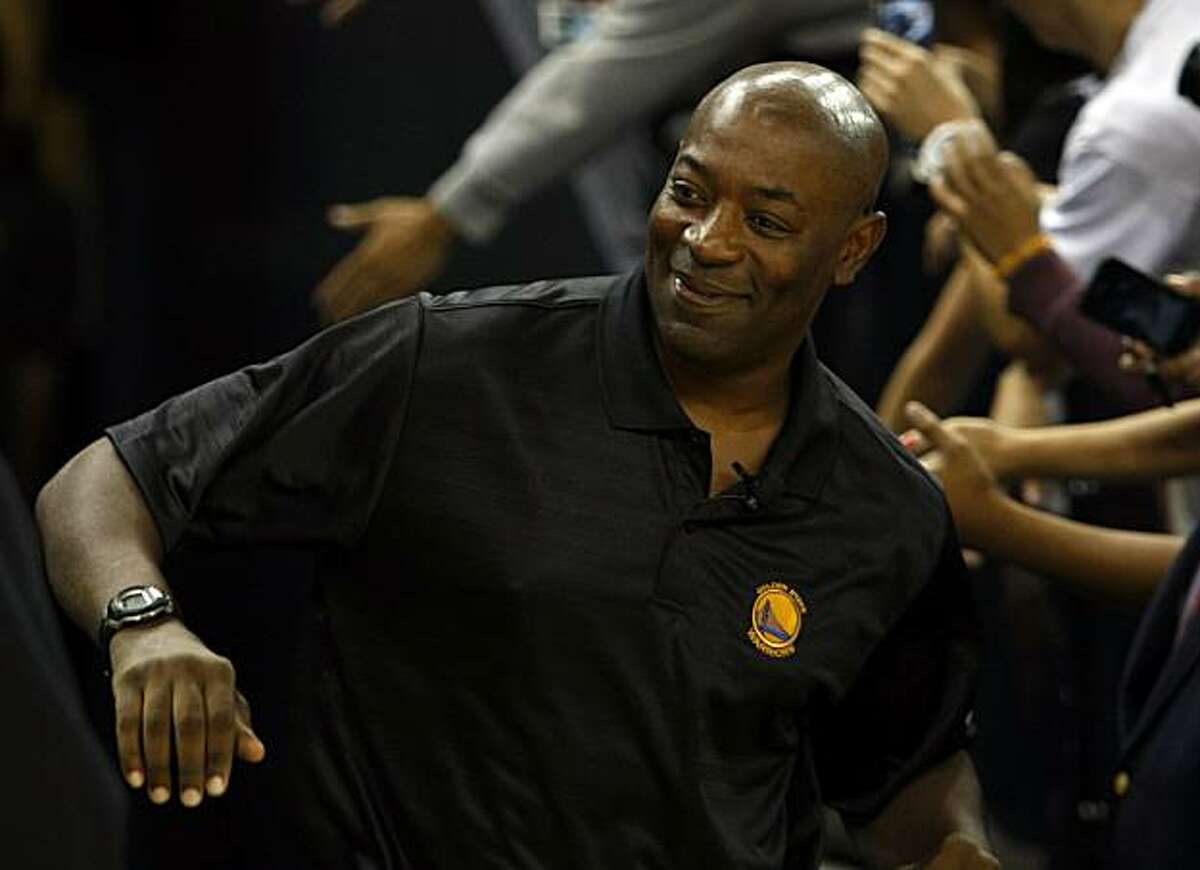 Head coach Keith Smart greats fans during an open practice at Oracle Arena Wednesday, October 6, 2010, Oakland, Calif. As the new season is set to begin the Golden State Warriors introduce new players and a largely new coaching staff to their fans.