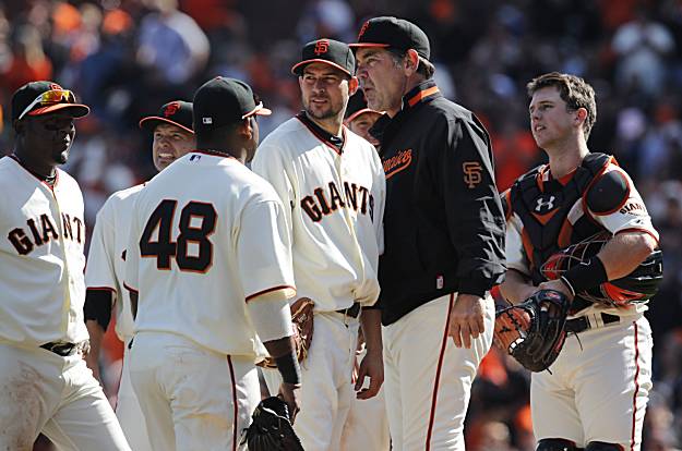 Giants manager Bruce Bochy and closer Brian Wilson celebrate a 3-0