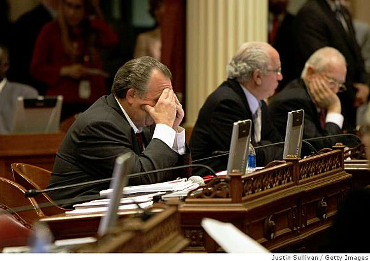 SACRAMENTO, CA - FEBRUARY 17: California state Sen. Robert Dutton (R-Rancho Cucamonga) holds his head in his hands during a session of the state Senate February 17, 2009 in Sacramento, California. The legislature is working to hammer out a budget that avoids thousands of layoffs and avoids briging state-funded construction projects to a halt. (Photo by Justin Sullivan/Getty Images)