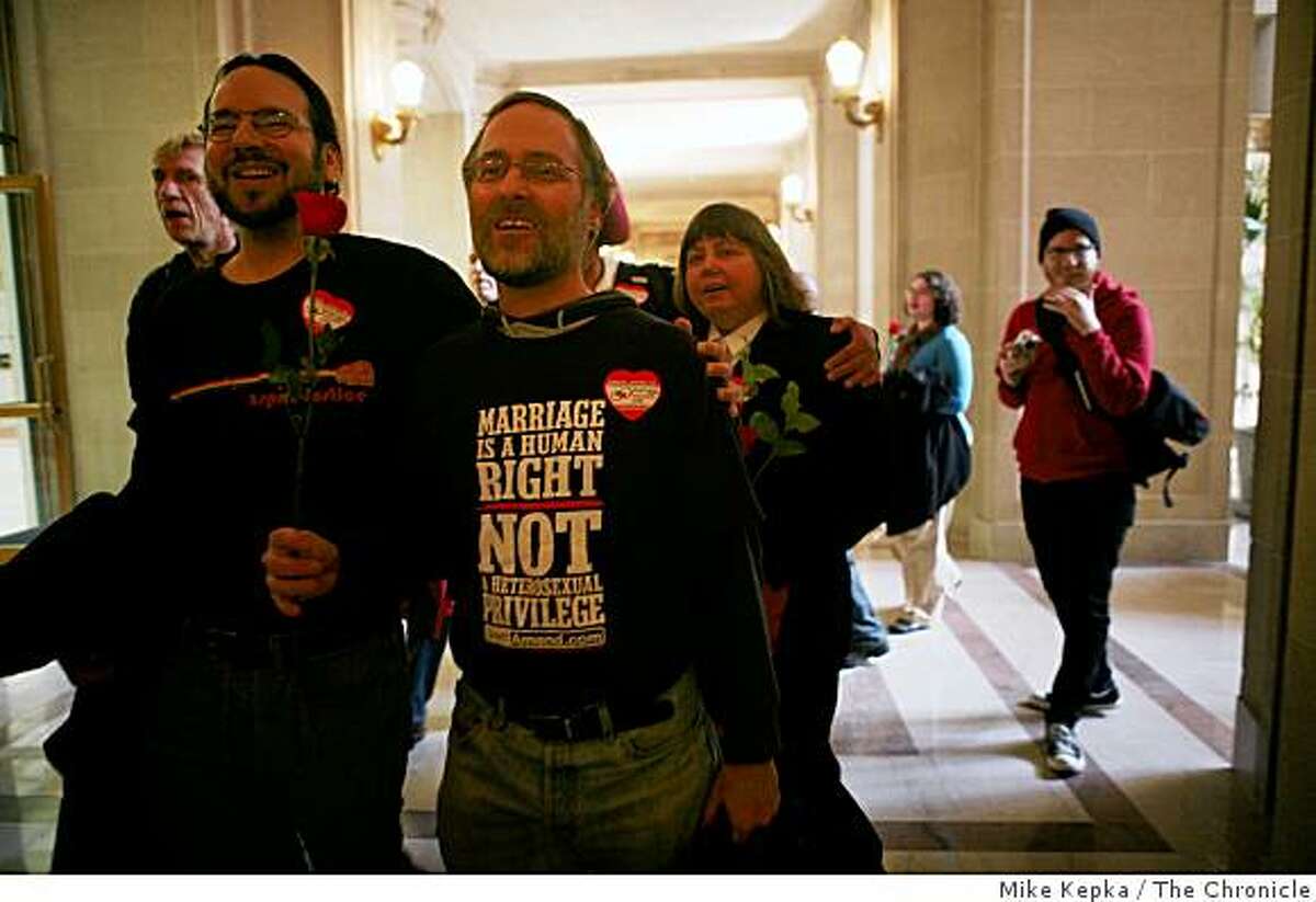 Five years after Mayor Gavin Newsom shocked the nation by marrying same-sex couples at San Francisco City Hall, Ted Guggenheim and Brian Davis (r), who were some of the first same-sex couples to be married in 2004, join other couples who came to thank the clerks in City Hall with a rose on Thursday Feb. 12, 2009 in San Francisco, Calif.