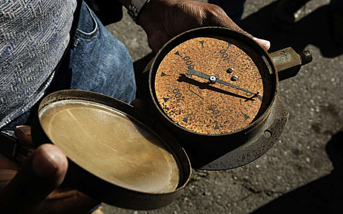 Garth Mitchell of Richmond picked up a souvenir, a steam pressure gauge, from the locomotive repair shop, as he joined other railroad buffs and historians, in West Oakland, Calif. on Thursday Sept. 23, 2010, for one last glimpse, as Union Pacific is scheduled to begin demolition of the building which was built in 1874.