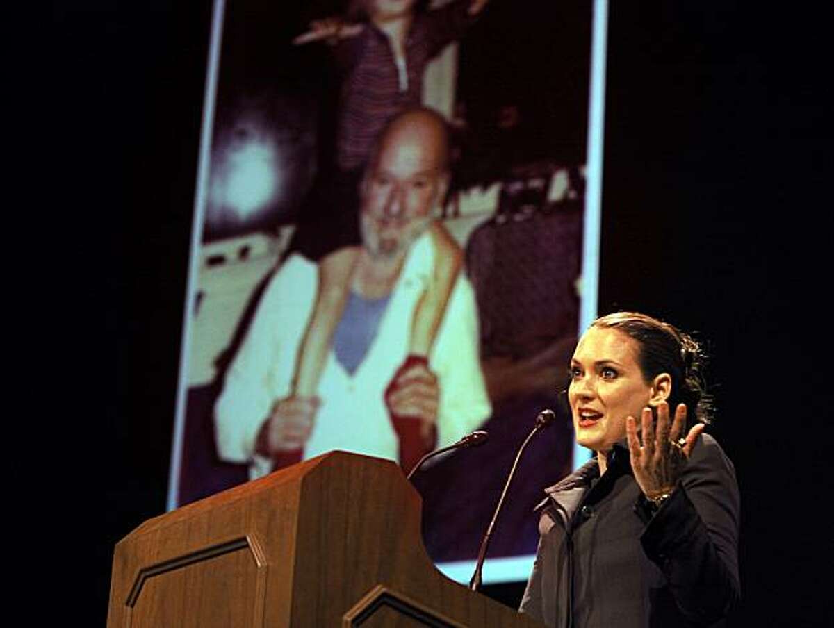 Winona Ryder realizes that the projected photo is of her on Ferlinghetti's shoulders as a child after reciting on of his poems at the Herbst Theatre Saturday, October 2, 2010, San Francisco, Calif. Lawrence Ferlinghetti, poet and cofounder of City Lights Bookstore, is honored with the Barbary Coast Award during Litquake, San Francisco's Literary Festival.