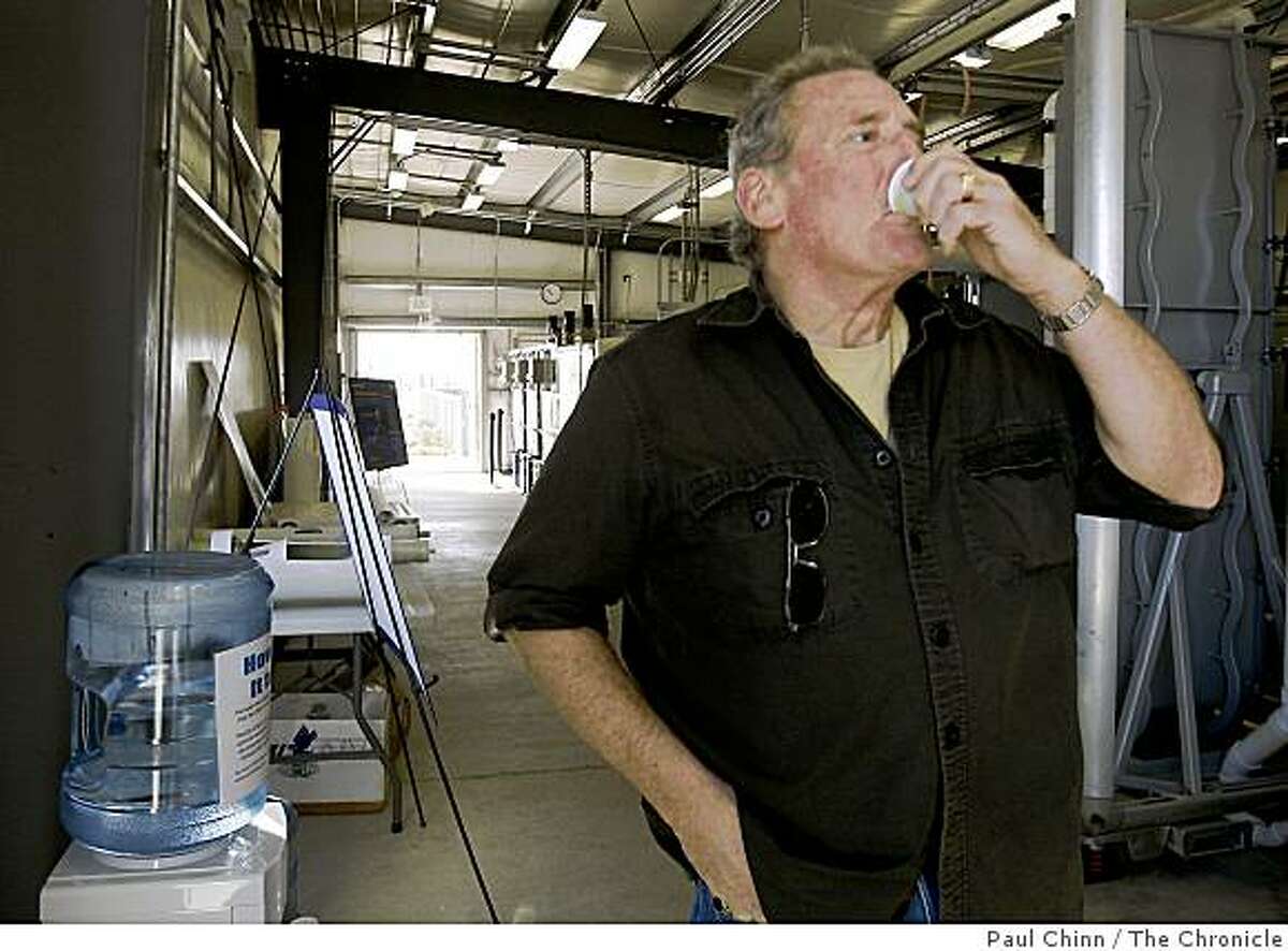 Mike Morris samples drinking water treated by a desalination plant.
