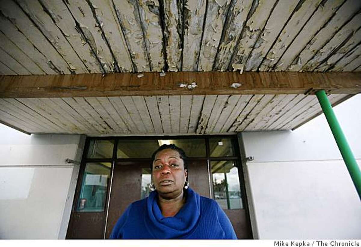 As Congress works to finalize the $789 Billion stimulus package, Seyana Mawusi, principal of West Oakland Middle School, stands under the paint peeling ceiling of her school on Thursday Feb. 12, 2009. She hopes the school will be a recipient of some of the money.