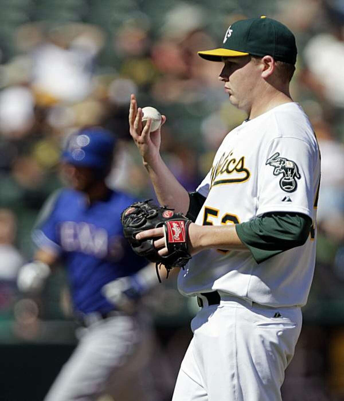 Oakland Athletics' Trevor Cahill, right, regroups as Texas Rangers' Jeff Francoeur, left, runs the bases after hitting a home run during the fourth inning of a baseball game Sunday, Sept. 26, 2010, in Oakland, Calif.