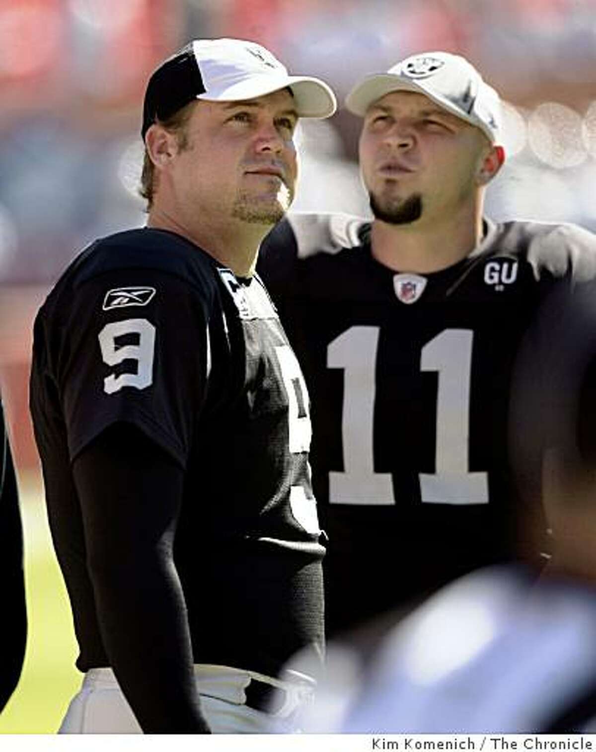 The jersies of Oakland Raiders punter Shane Lechler, left, and kicker Sebastian Janikowski come together to form "911" as the teacm warms up before the Raiders play the Miami Dolphins at Dolphins Stadium in Miami, Fla., on Sunday, Nov. 16, 2008