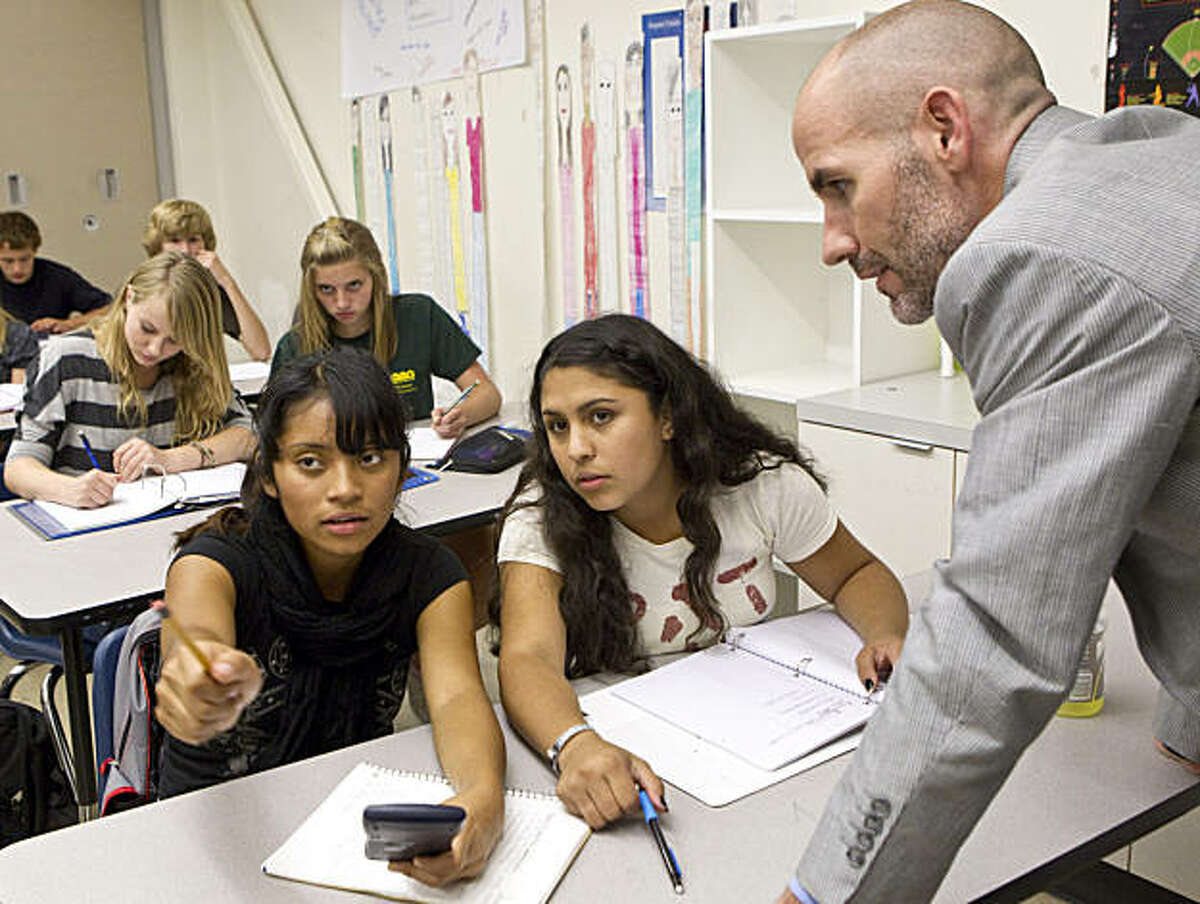 Summit Preparatory Charter High School Executive Director Todd Dickson helps Arleni Barrios (left) and Adriana Corrales while observing their science class at the school in Redwood City, Calif., on Friday, September 24, 2010.