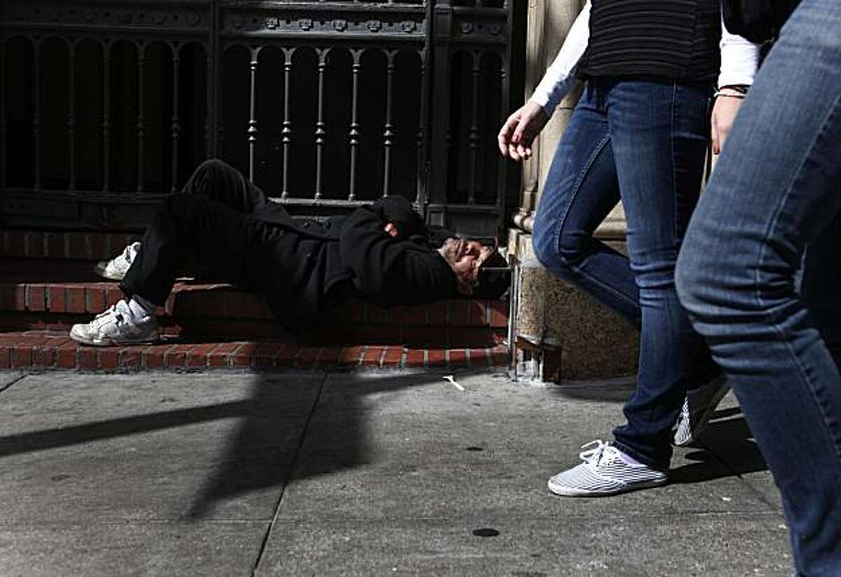 On the day the U.S. Census Bureau announced the start of a three day count of the city's homeless population, Rafael Bamba, 55, who has been homeless for the past 10 years, sleeps on the steps of Glide Memorial Church on Tuesday March 30, 2010 in San Francisco, Calif.