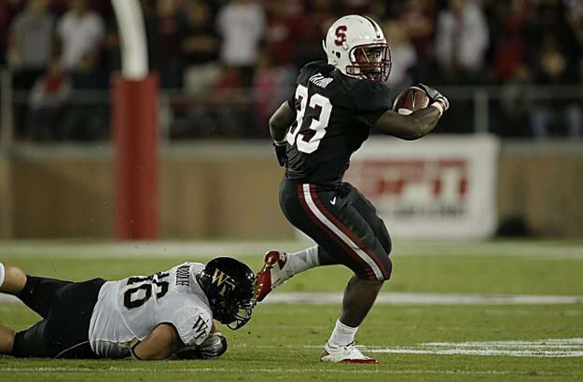 Stanford's Sepfan Taylor, (33) gets outside of defender Matt Woodlief, (46) on a first quarter run, as the Stanford Cardinal takes on Wake Forest in college football action at Stanford Stadium in Palo Alto, Ca. on Saturday Sept. 18, 2010.