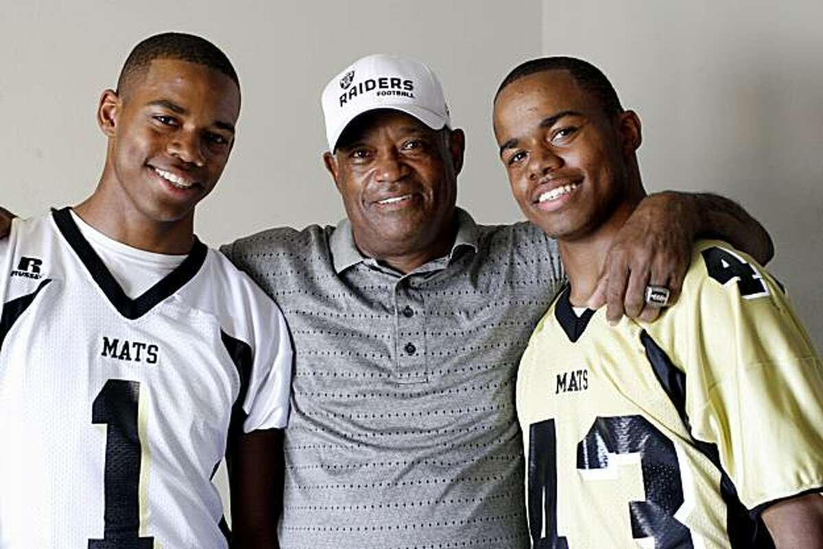 George Atkinson III, left, and his twin brother Josh Atkinson, right, are sons of George Atkinson, Jr., center, who was a defensive back for the Oakland Raiders in the 1970s, and now helps out coaching his sons' football team at Granada High School in Livermore, Calif. on Sunday, Sept. 7, 2008.