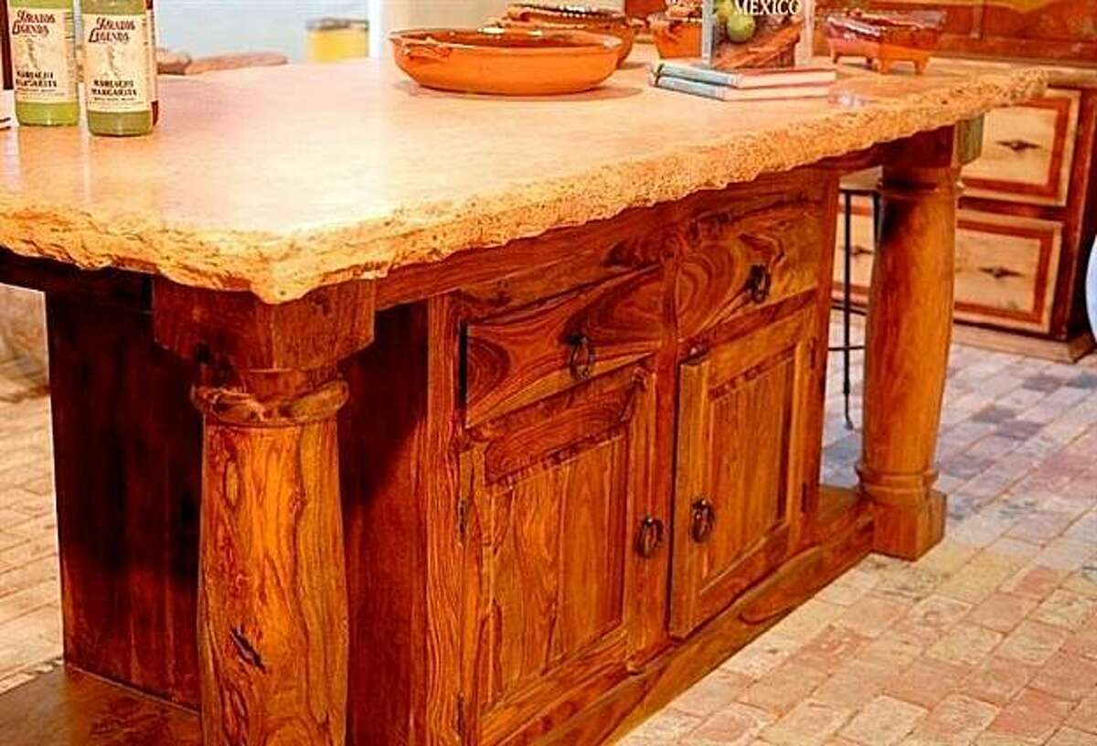 Salsa Trading Company's custom islands are made out of reclaimed rosewood. The Baker's Island has four deep drawers for storage and a 3-inch thick travertine top.