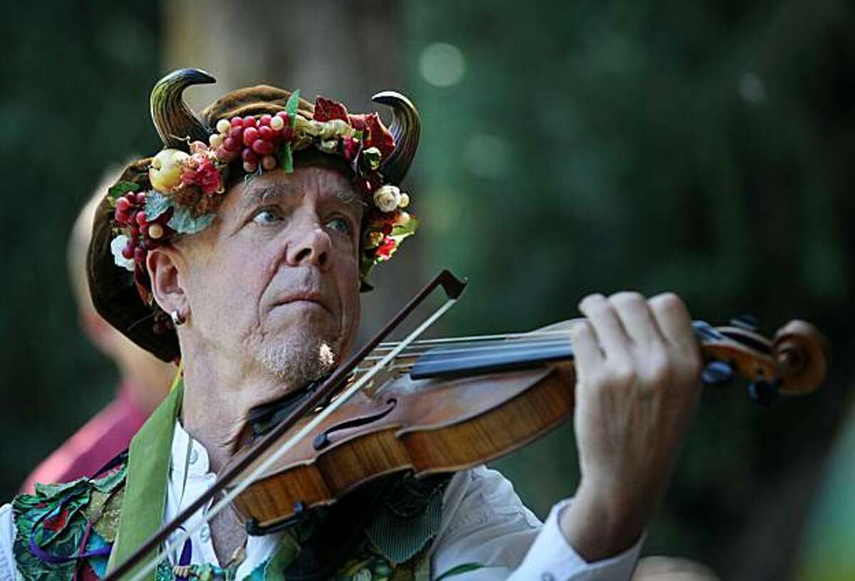 Cliff Stevens warms up his fiddle before participating in a mass antler dance organized by the California Revels at Joaquin Miller Park on Monday Sept. 6, 2010 in Oakland, Calif. The dance, performed for the first time at this park, is part of a 1,000-old-old annual tradition done in Abbots Bromley, England. Some say the strange unexplained dance celebrates the great mystery of life.